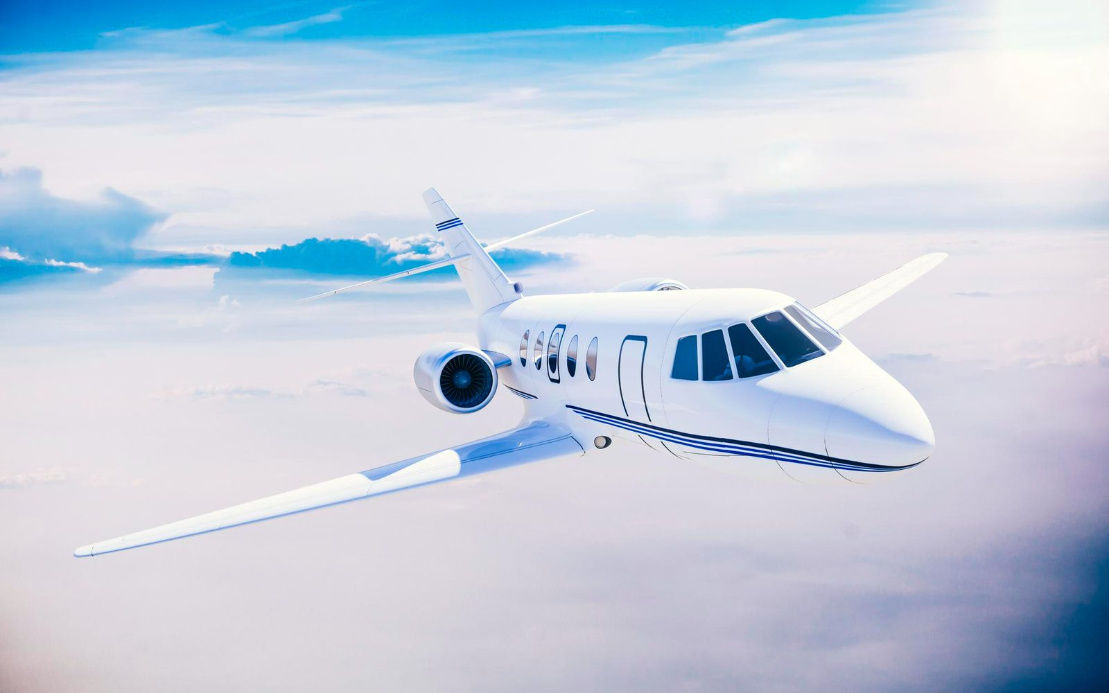 A small jet flying above the clouds
