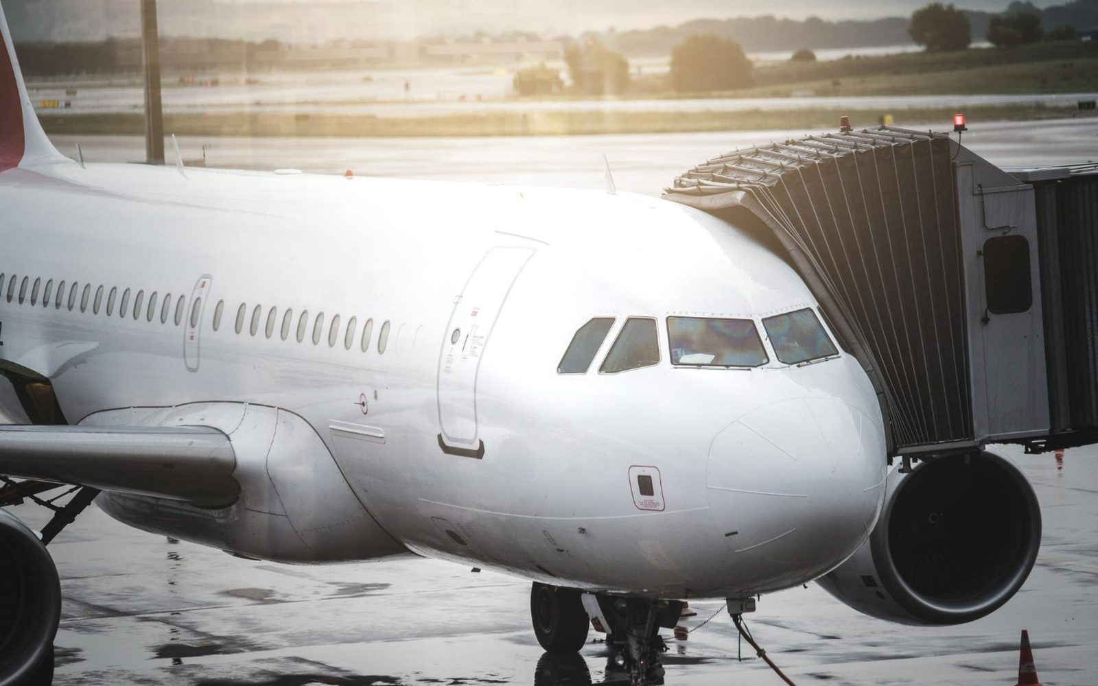 An airliner at the gate beside a boarding bridge