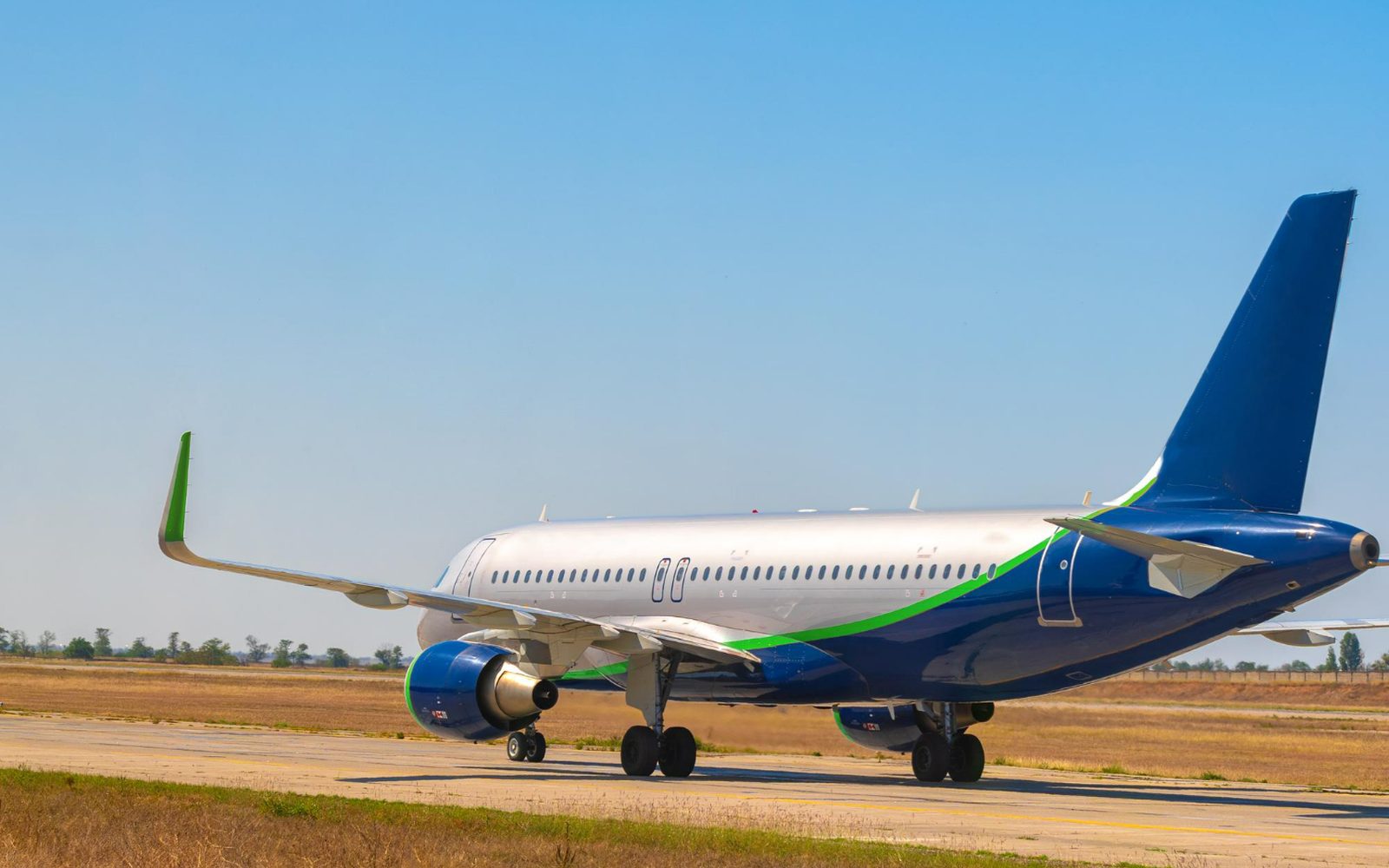 An airliner taxiing along the runway on a clear day