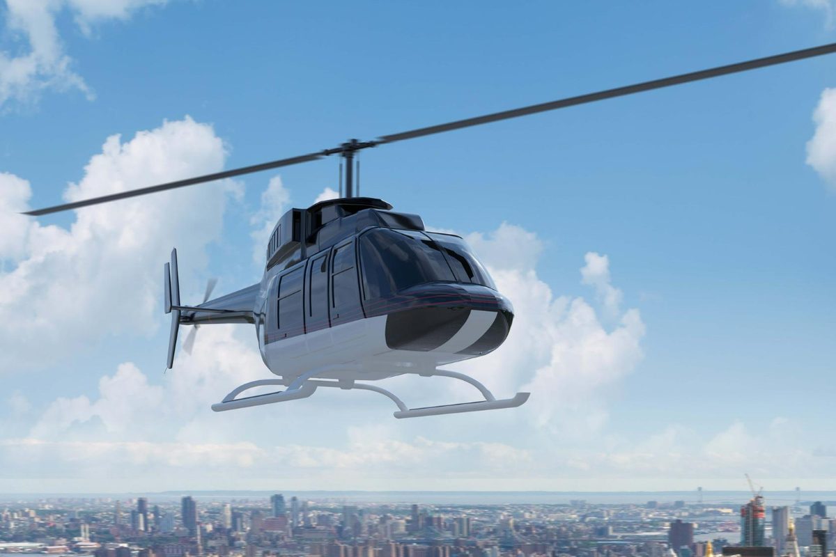 A helicopter in flight above a city skyline